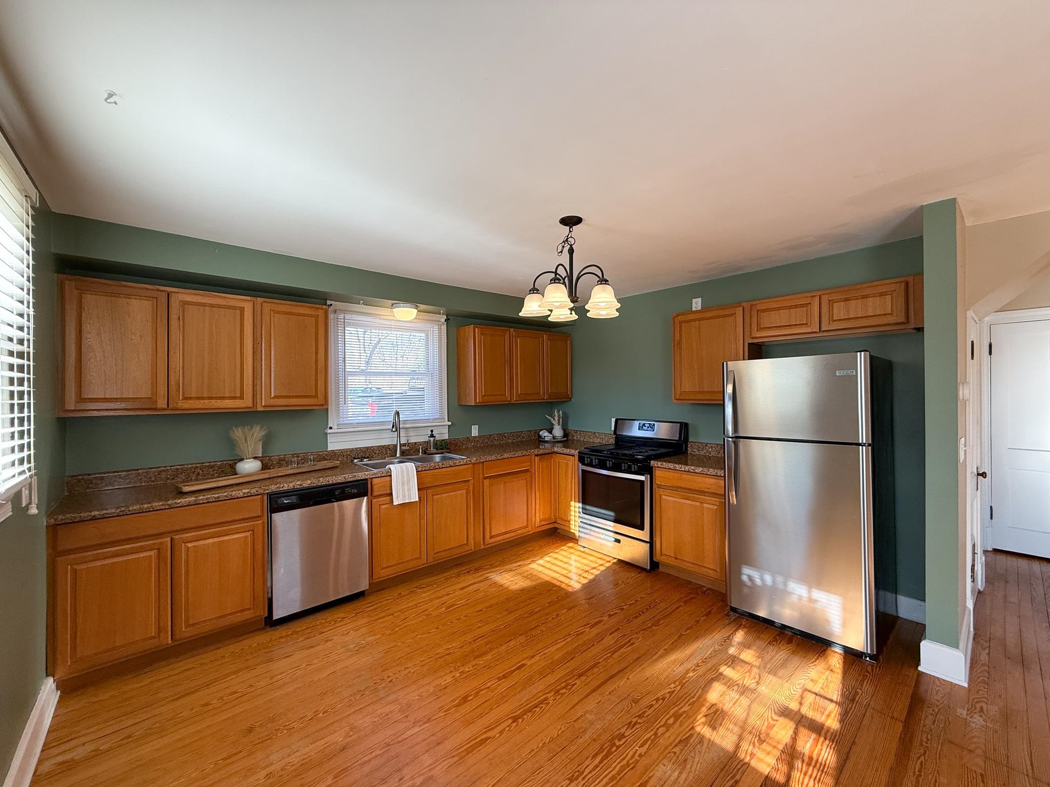 703 Monroe Street Staunton, VA 24401 - Photo 13 of 21 a kitchen with granite countertop stainless steel appliances and wooden cabinets