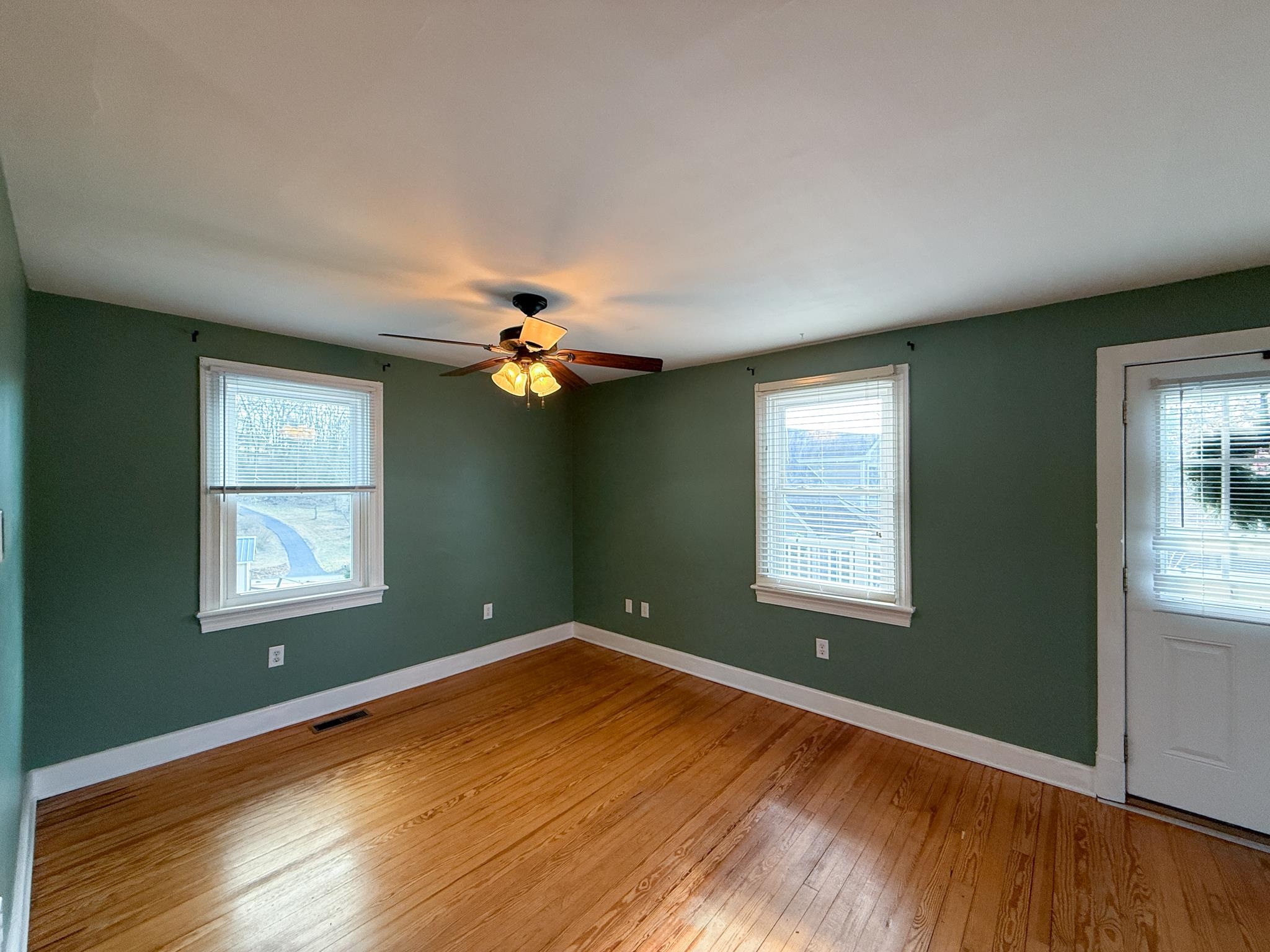 703 Monroe Street Staunton, VA 24401 - Photo 14 of 21 a view of empty room with wooden floor and fan