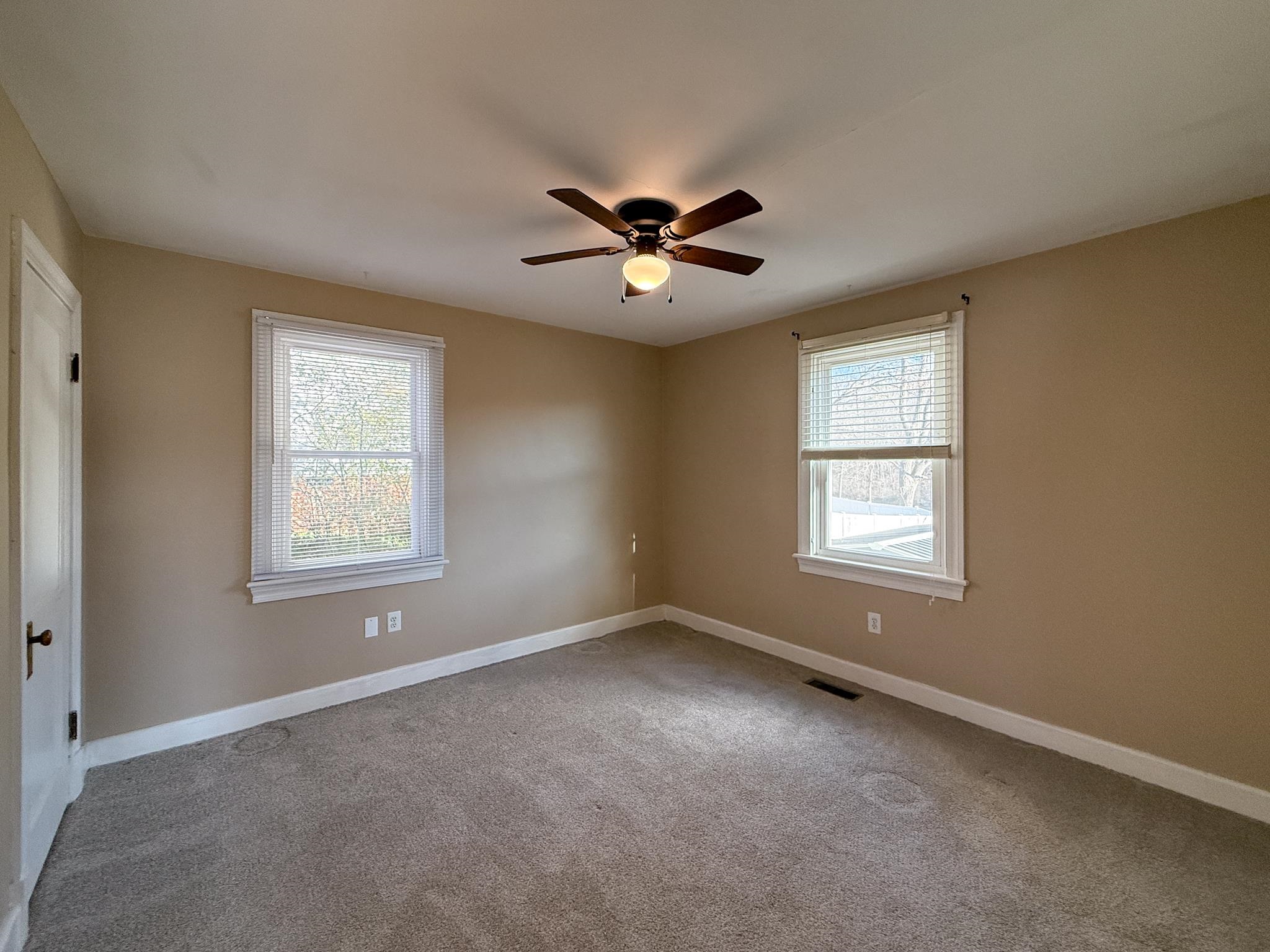 703 Monroe Street Staunton, VA 24401 - Photo 16 of 21 a view of a room with windows and chandelier fan