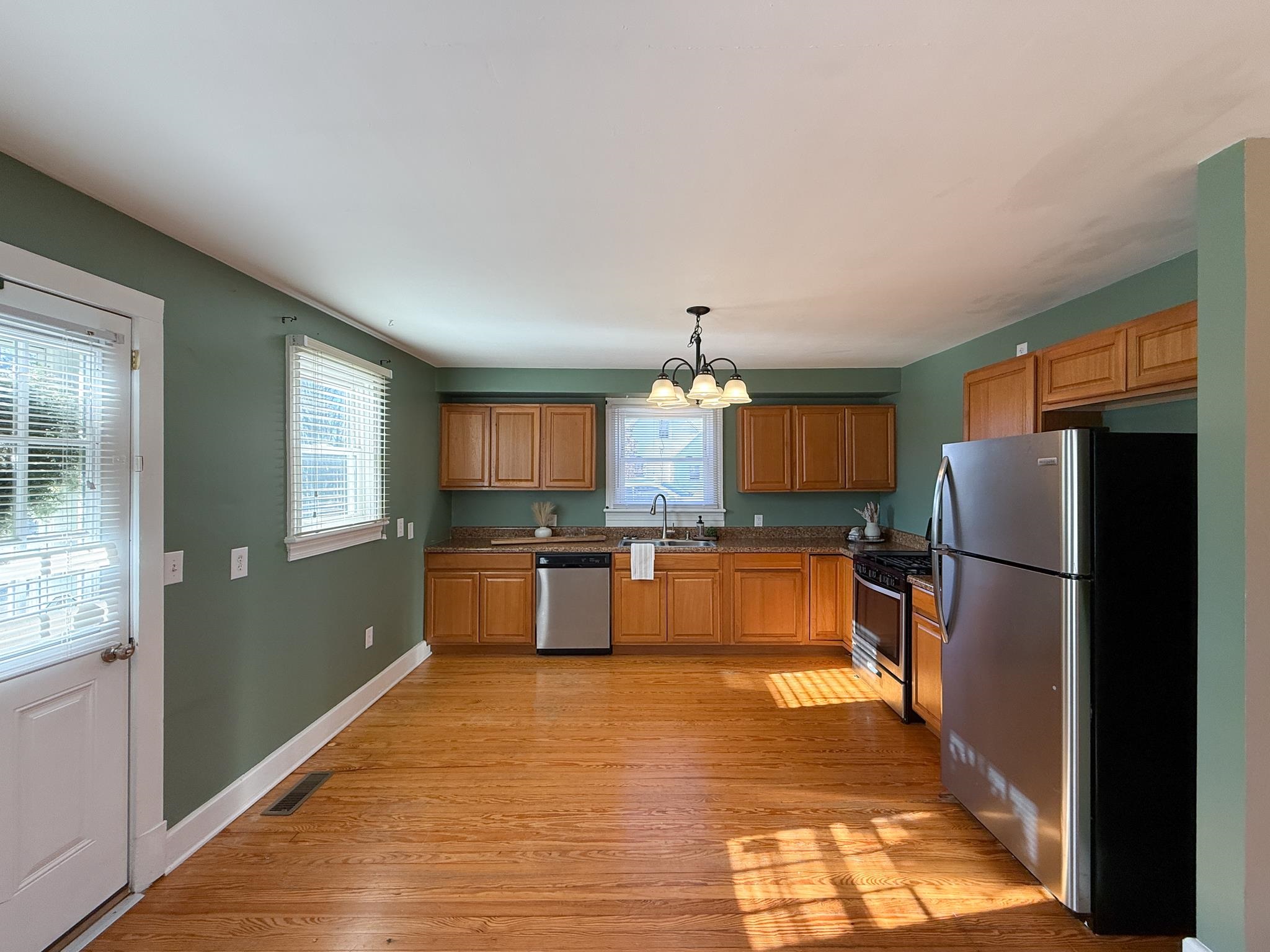 703 Monroe Street Staunton, VA 24401 - Photo 10 of 21 a large kitchen with stainless steel appliances a refrigerator and a stove top oven