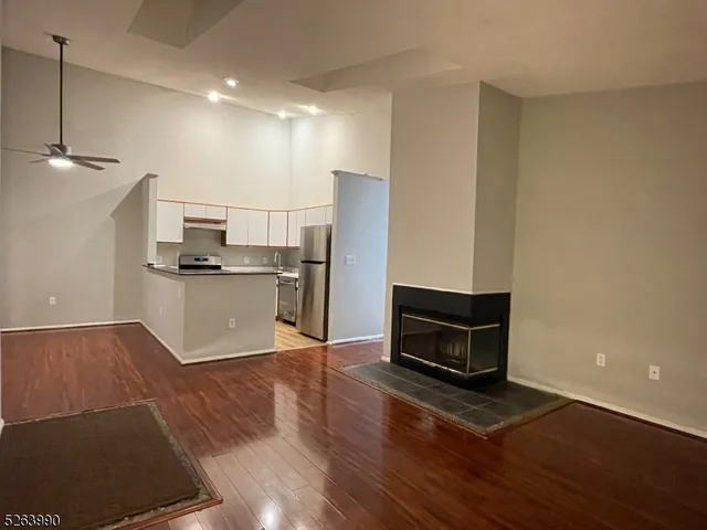 a kitchen with a refrigerator and a stove top oven