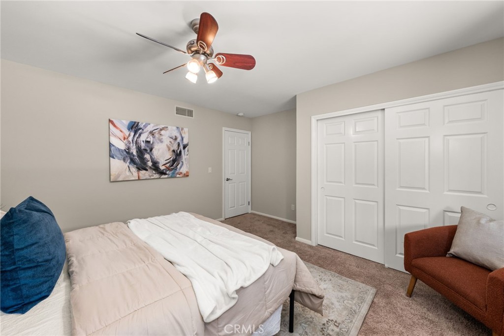 2465 Via Oeste Drive Fallbrook, CA 92028 - Photo 24 of 44 a bedroom with a bed and a chandelier