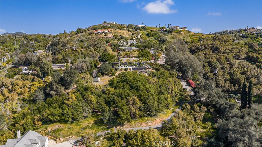2465 Via Oeste Drive Fallbrook, CA 92028 - Photo 41 of 44 a view of a large building with mountains in the background