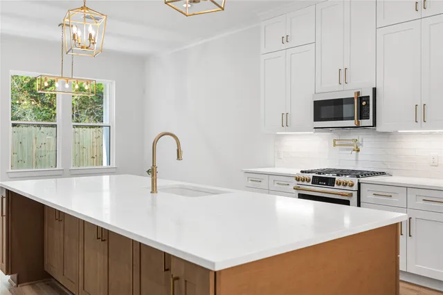 a kitchen with granite countertop a stove and a sink