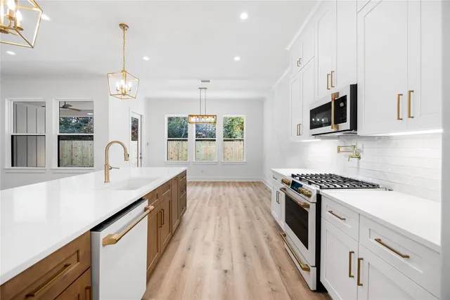 a kitchen with a sink stove and cabinets