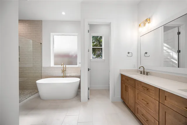 a view of empty room with wooden floor and ceiling fan