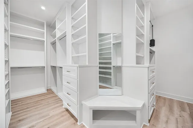 a spacious bedroom with a bed and a window