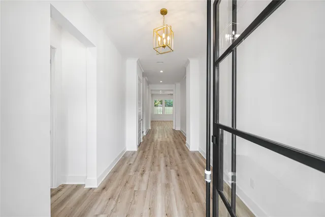 a view of hallway with wooden floor