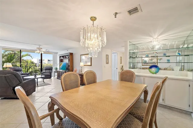 a view of a dining room with furniture and a chandelier