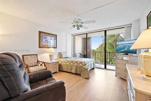 a bedroom with furniture and a large window