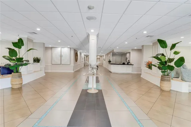 a lobby with furniture and potted plant