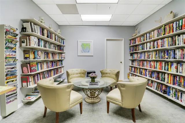 a living room with furniture and a book shelf