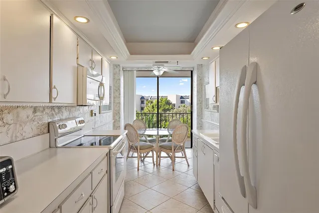 a kitchen with a table chairs and a refrigerator