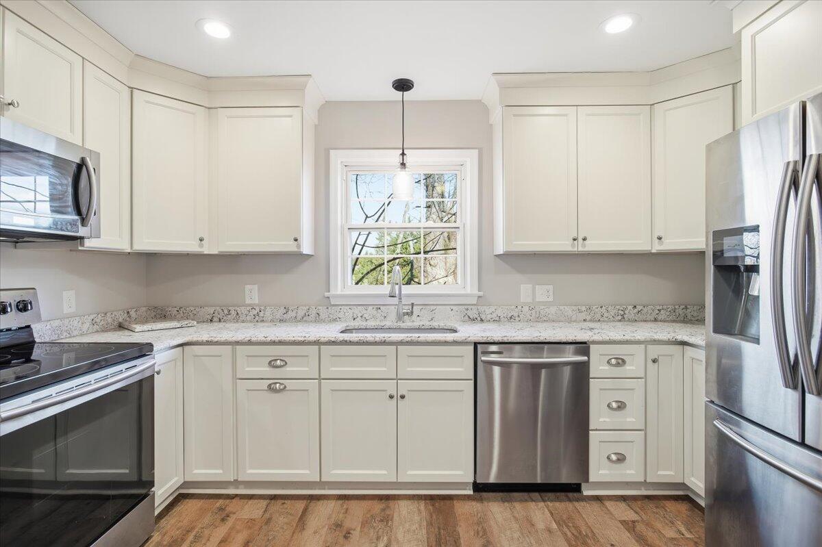 2127-2129 Moneta Road Bedford, VA 24523 - Photo 11 of 66 a kitchen with stainless steel appliances granite countertop a sink and cabinets with wooden floor