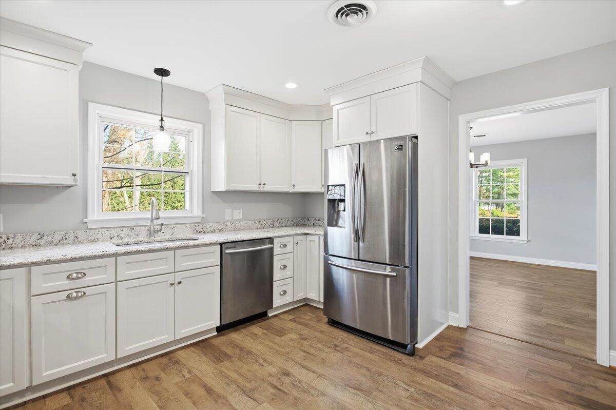 2127-2129 Moneta Road Bedford, VA 24523 - Photo 12 of 66 a kitchen with granite countertop appliances cabinets wooden floor and a window