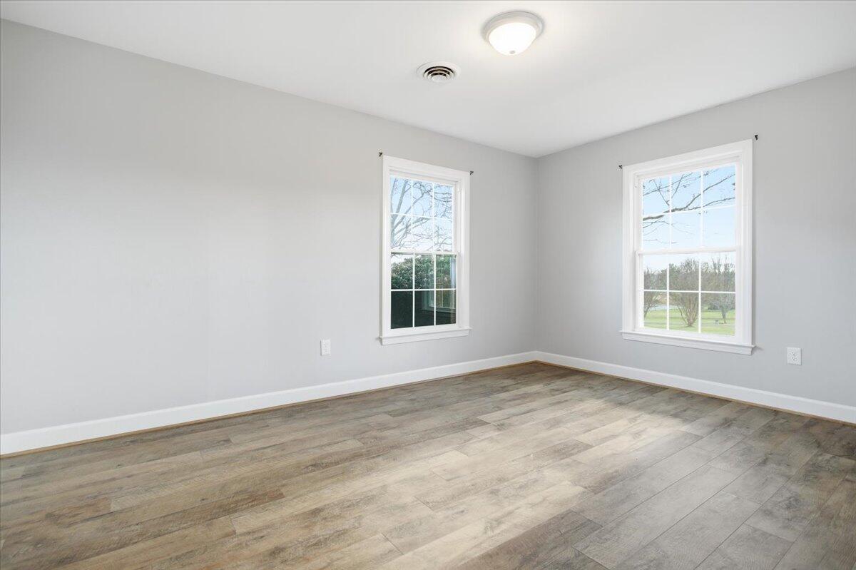2127-2129 Moneta Road Bedford, VA 24523 - Photo 22 of 66 an empty room with wooden floor and windows