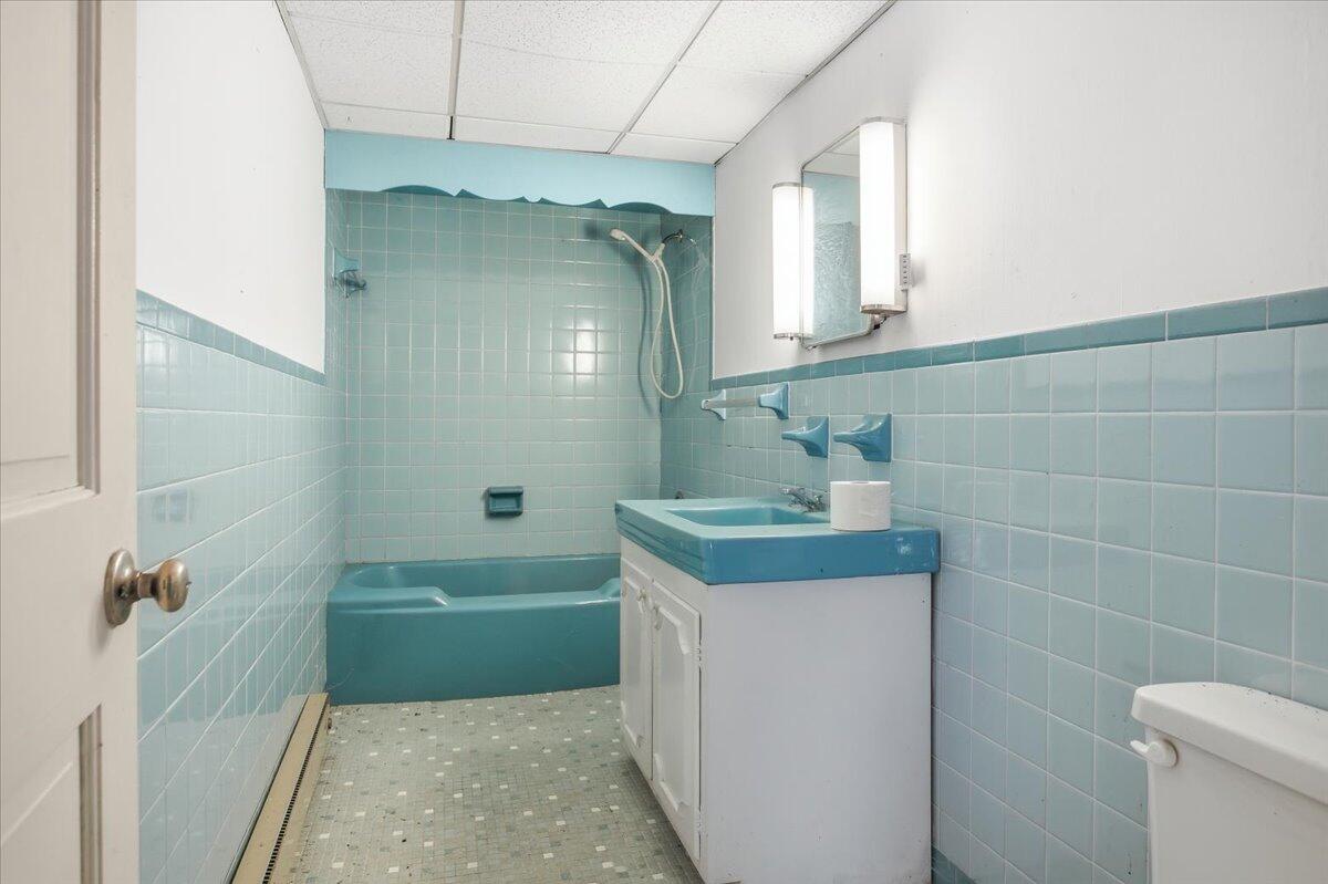 2127-2129 Moneta Road Bedford, VA 24523 - Photo 30 of 66 a bathroom with a granite countertop sink a mirror and a shower