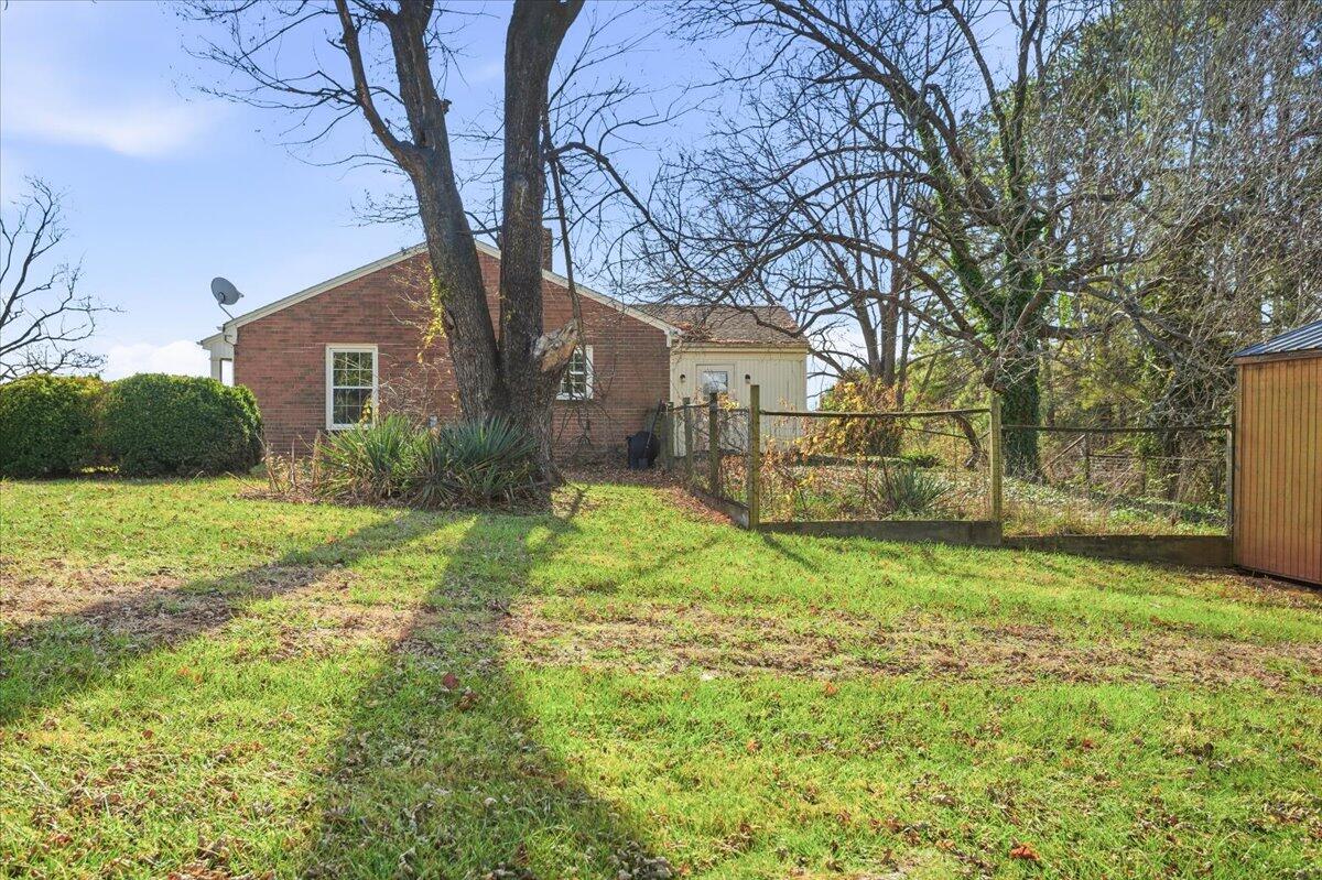 2127-2129 Moneta Road Bedford, VA 24523 - Photo 31 of 66 a yellow house in middle of the forest