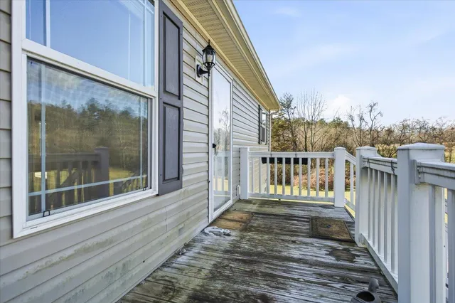 a kitchen with stainless steel appliances granite countertop a stove top oven a sink a counter space and a window