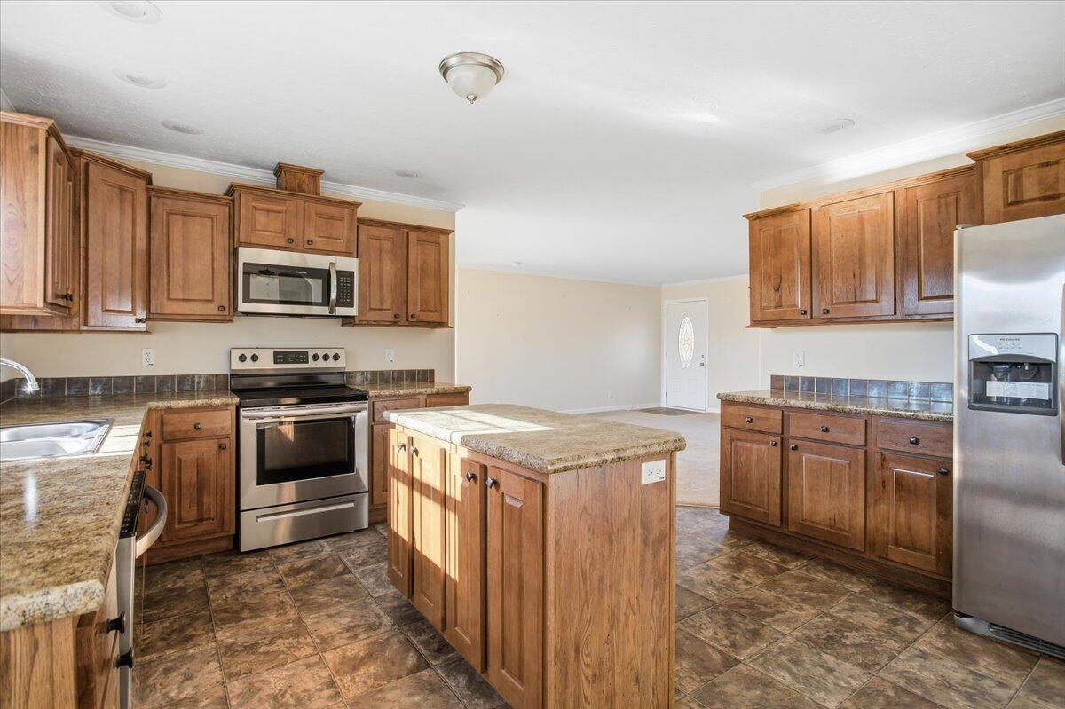 2127-2129 Moneta Road Bedford, VA 24523 - Photo 48 of 66 a kitchen with stainless steel appliances granite countertop a stove top oven a sink and dishwasher