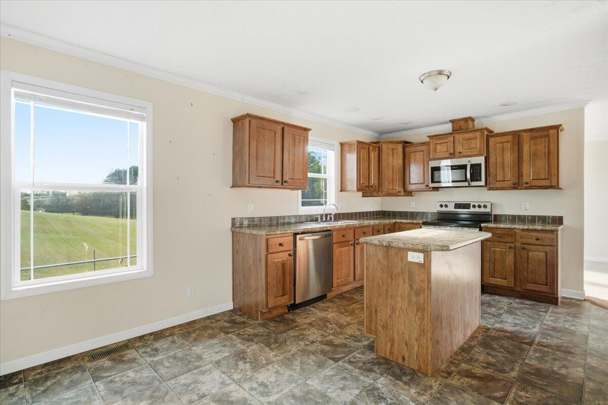 2127-2129 Moneta Road Bedford, VA 24523 - Photo 49 of 66 a kitchen with stainless steel appliances granite countertop a stove top oven a sink a counter space and a window