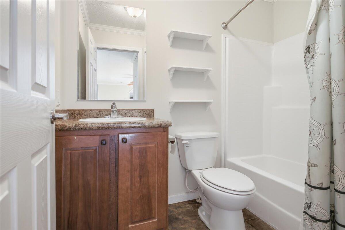 2127-2129 Moneta Road Bedford, VA 24523 - Photo 61 of 66 a bathroom with a granite countertop toilet sink and mirror