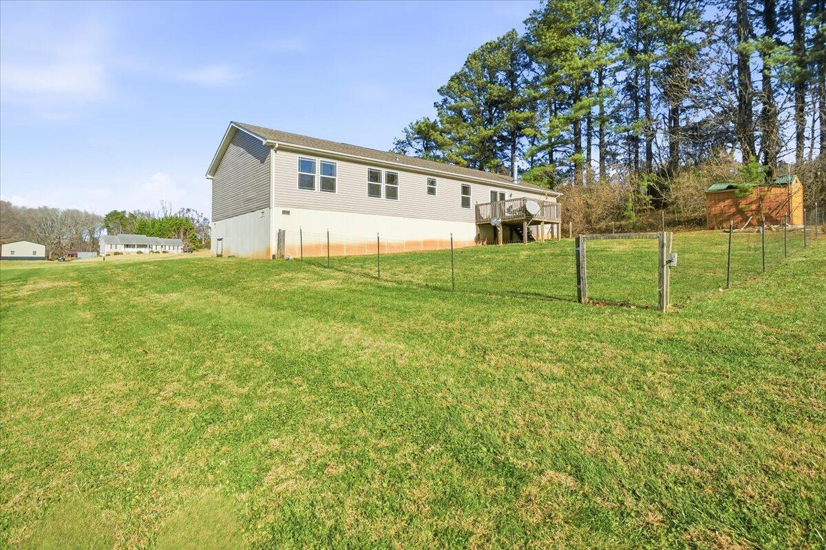 2127-2129 Moneta Road Bedford, VA 24523 - Photo 64 of 66 a view of a backyard with plants and large trees