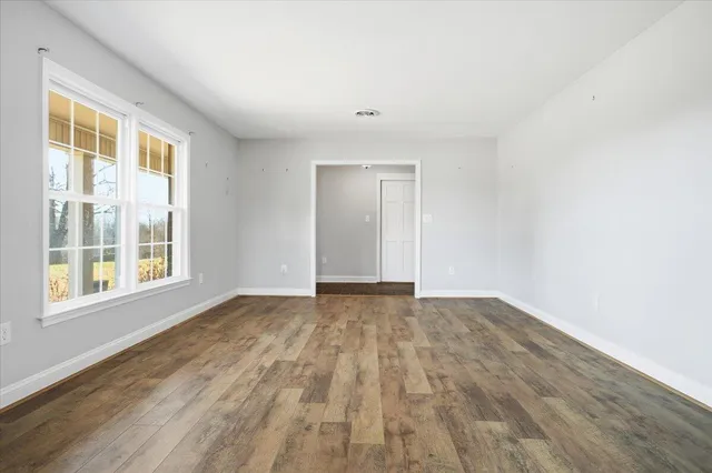 a kitchen with stainless steel appliances granite countertop a sink and cabinets with wooden floor