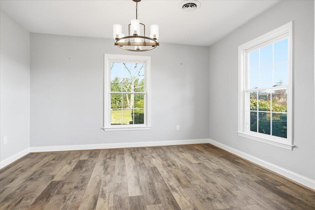 2127-2129 Moneta Road Bedford, VA 24523 - Photo 8 of 66 a view of an empty room with wooden floor and a window