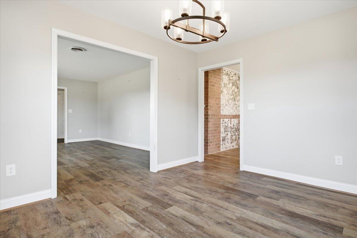 2127-2129 Moneta Road Bedford, VA 24523 - Photo 9 of 66 an empty room with wooden floor cabinet and windows