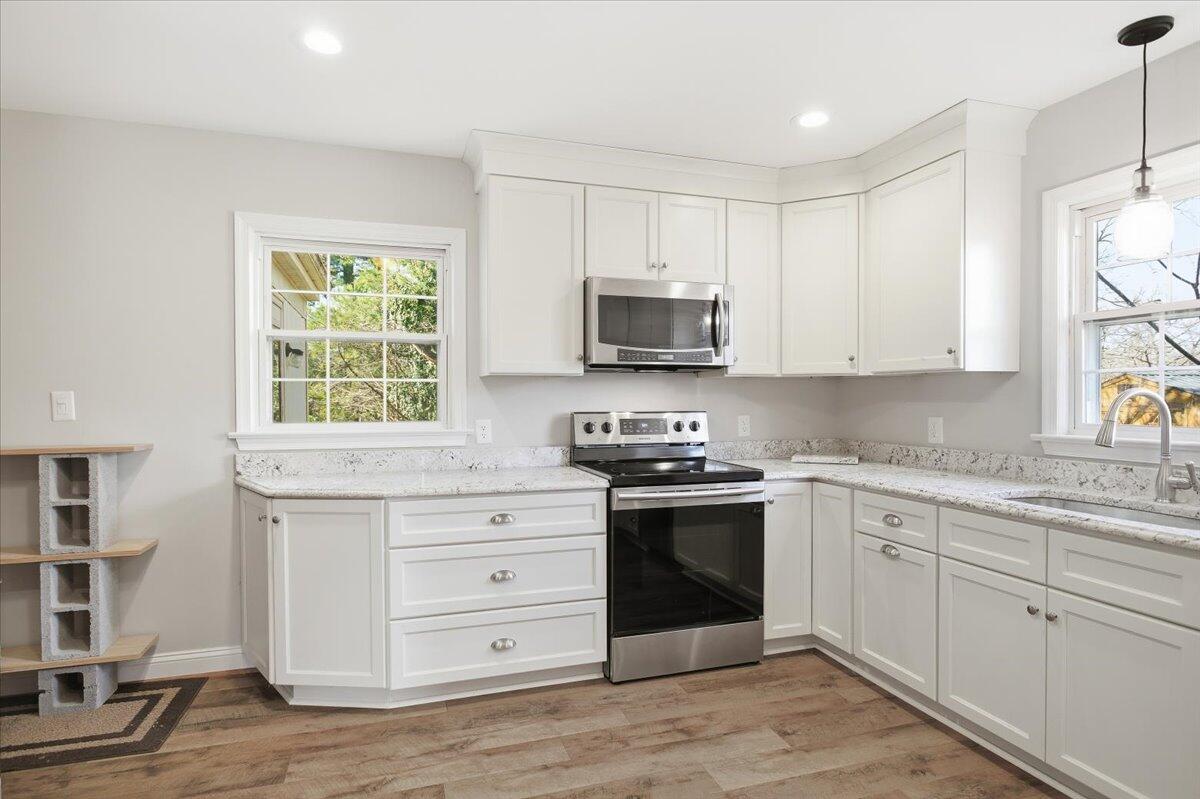 2127-2129 Moneta Road Bedford, VA 24523 - Photo 10 of 66 a kitchen with stainless steel appliances granite countertop a stove a sink and a microwave
