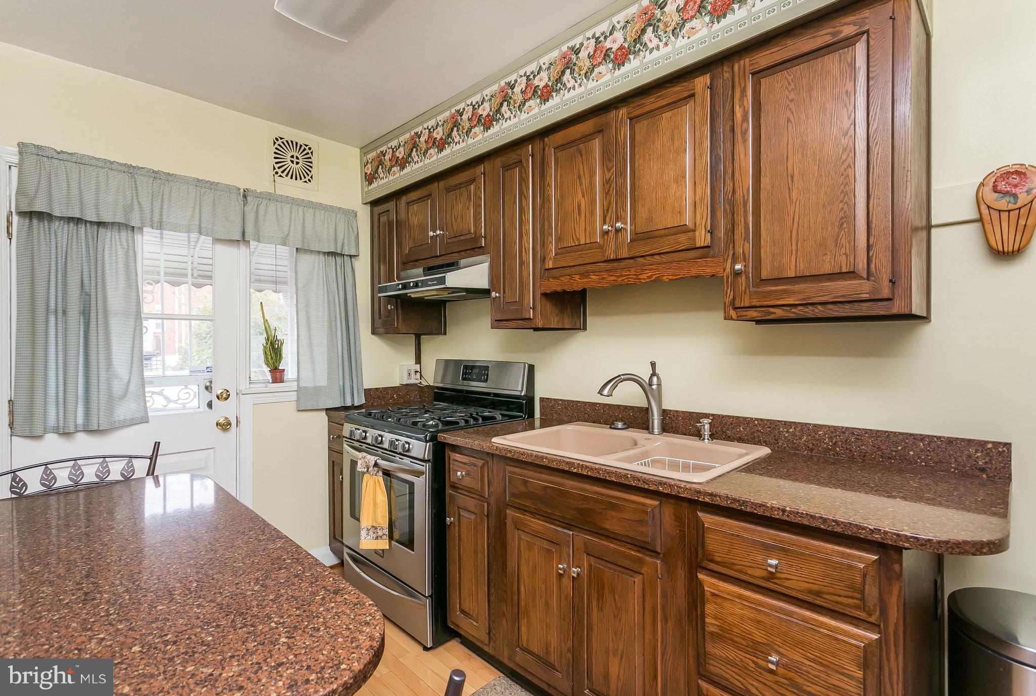 1000 Arncliffe Road Baltimore, MD 21221 - Photo 12 of 36 a kitchen with stainless steel appliances granite countertop a sink stove and cabinets