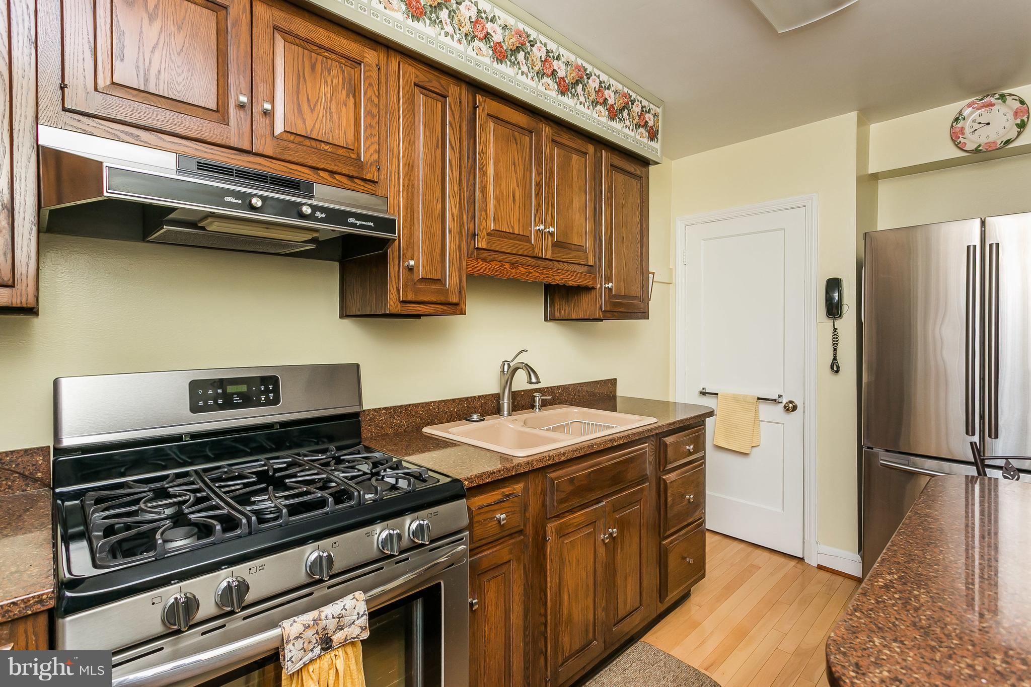 1000 Arncliffe Road Baltimore, MD 21221 - Photo 14 of 36 a kitchen with stainless steel appliances granite countertop a stove a refrigerator and a sink