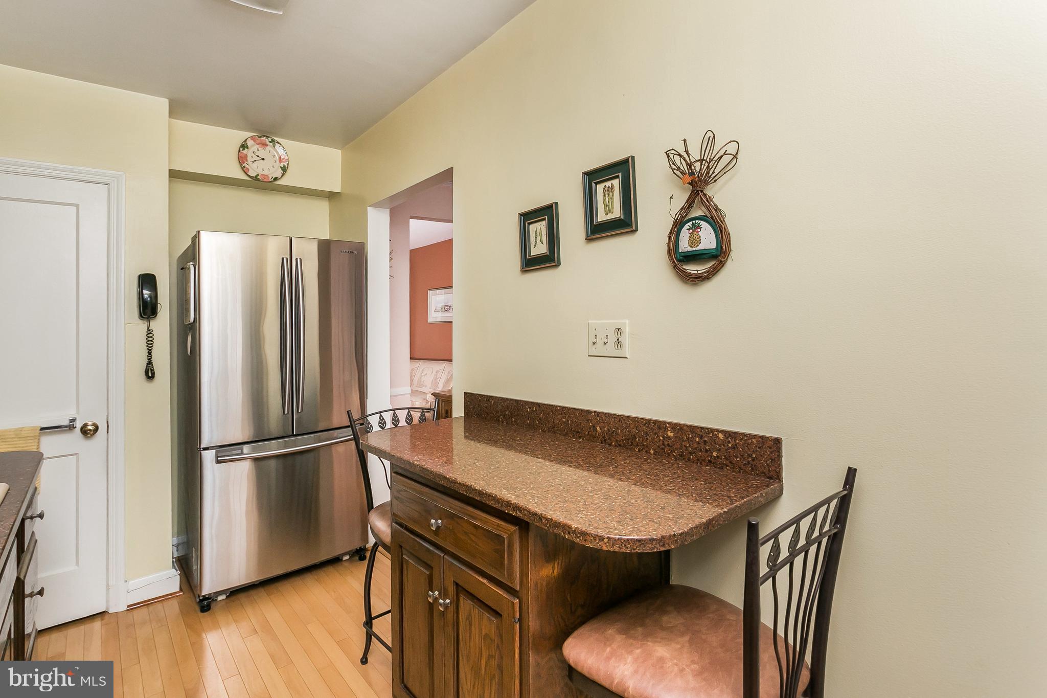 1000 Arncliffe Road Baltimore, MD 21221 - Photo 15 of 36 a kitchen with stainless steel appliances granite countertop a refrigerator a stove and a wooden floor