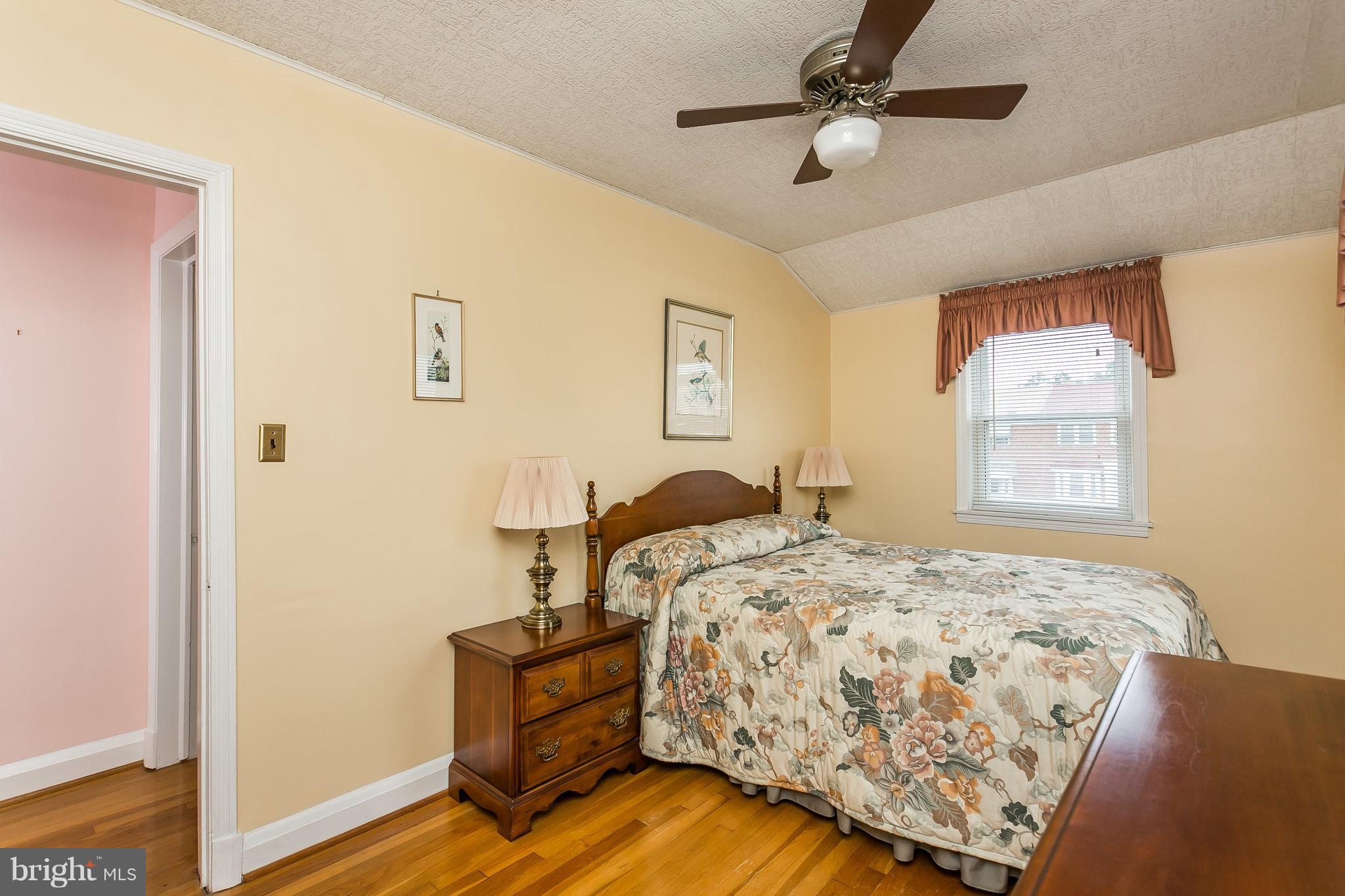 1000 Arncliffe Road Baltimore, MD 21221 - Photo 21 of 36 a bedroom with a bed and wooden floor
