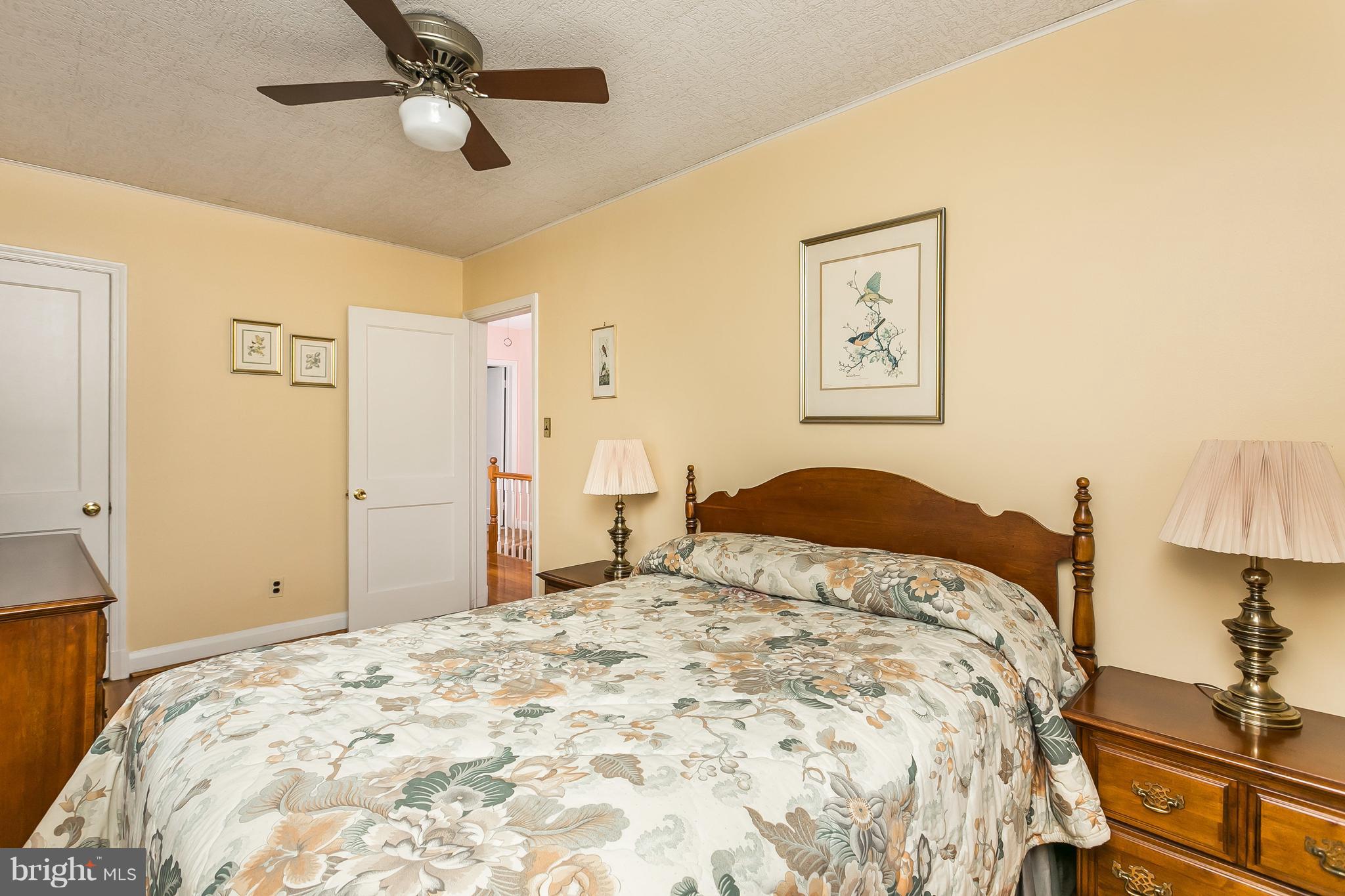 1000 Arncliffe Road Baltimore, MD 21221 - Photo 22 of 36 a bedroom with a large bed and a chandelier