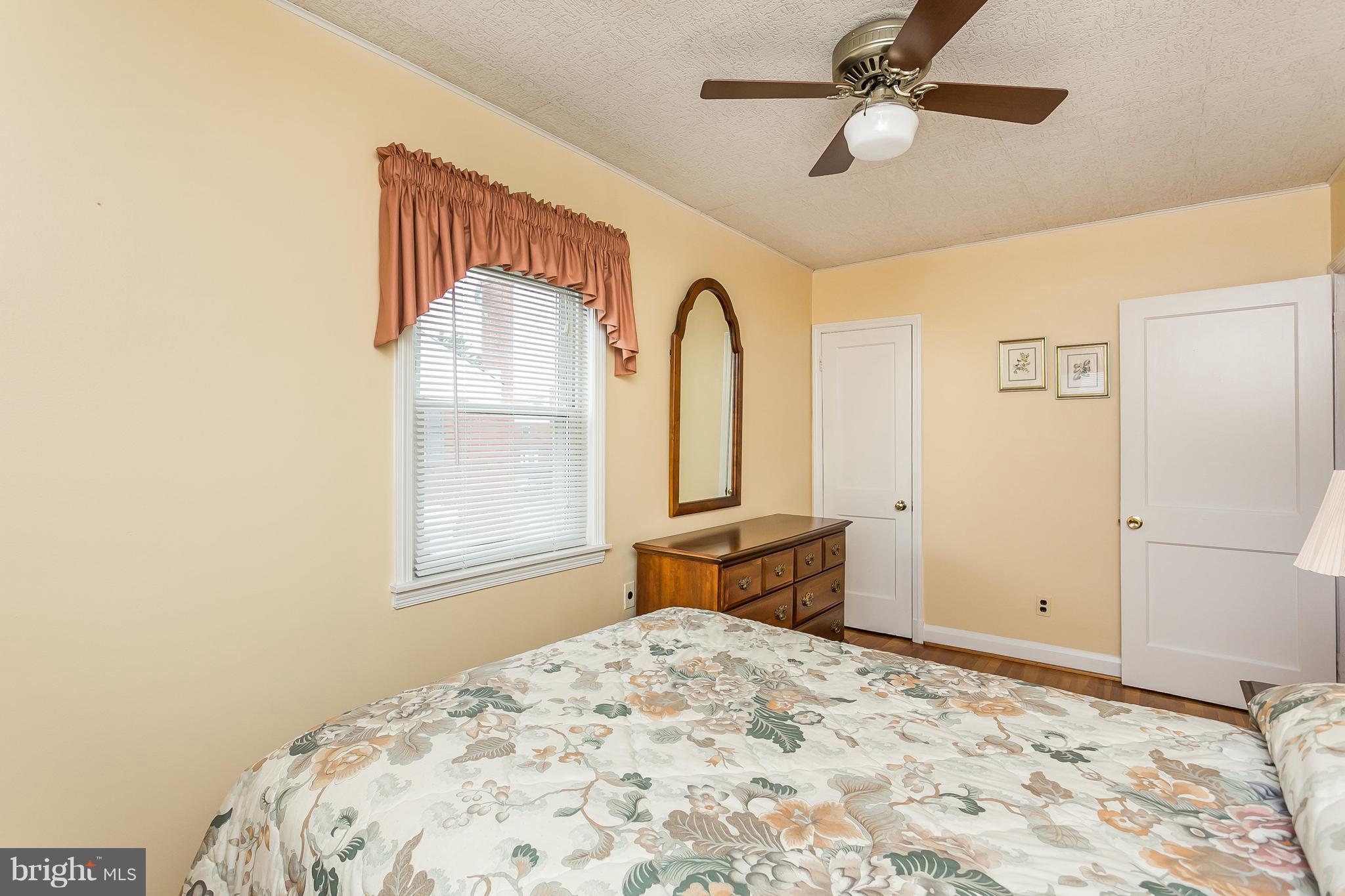 1000 Arncliffe Road Baltimore, MD 21221 - Photo 23 of 36 a bedroom with a bed dresser and a window