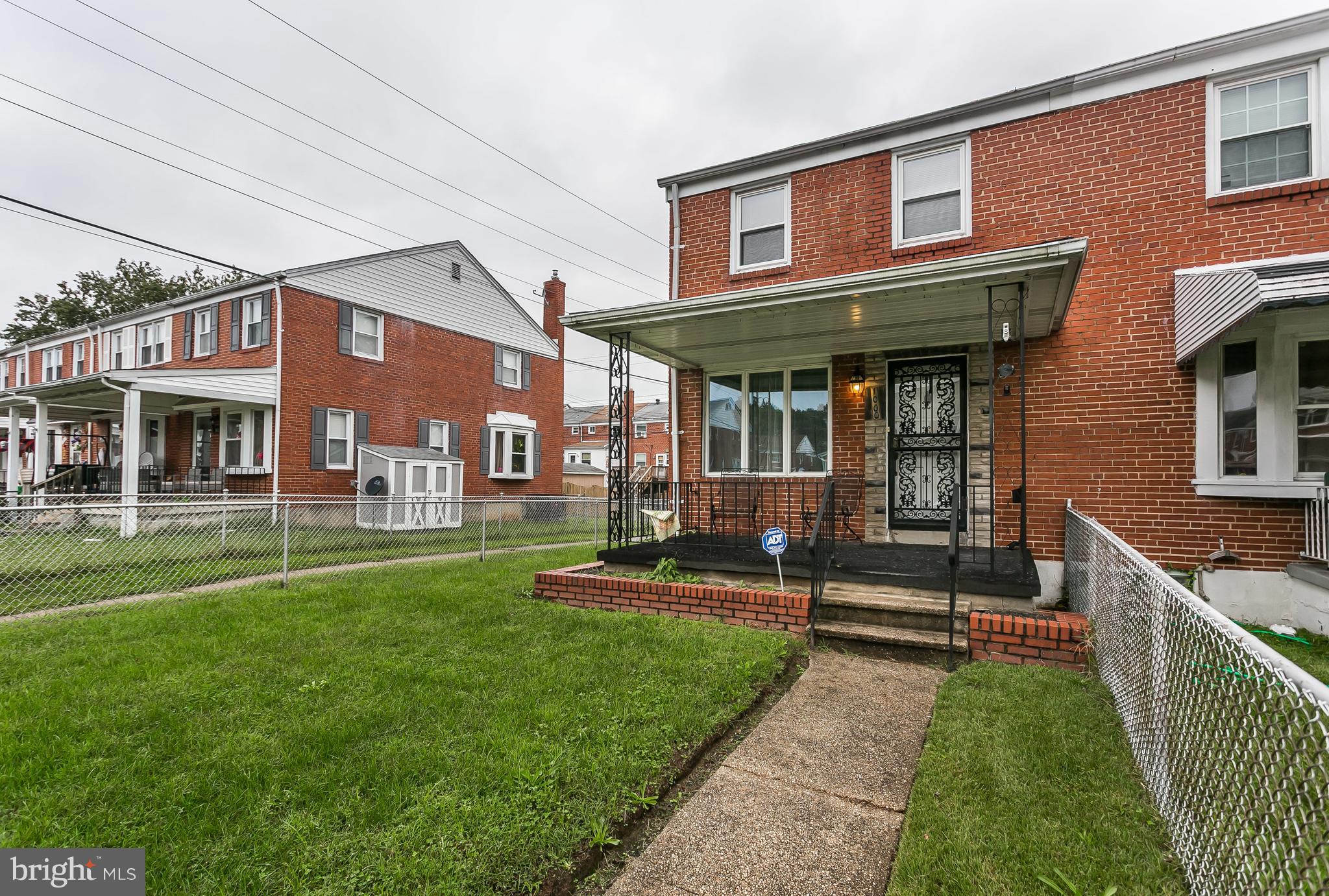 1000 Arncliffe Road Baltimore, MD 21221 - Photo 4 of 36 a front view of a brick house with a yard