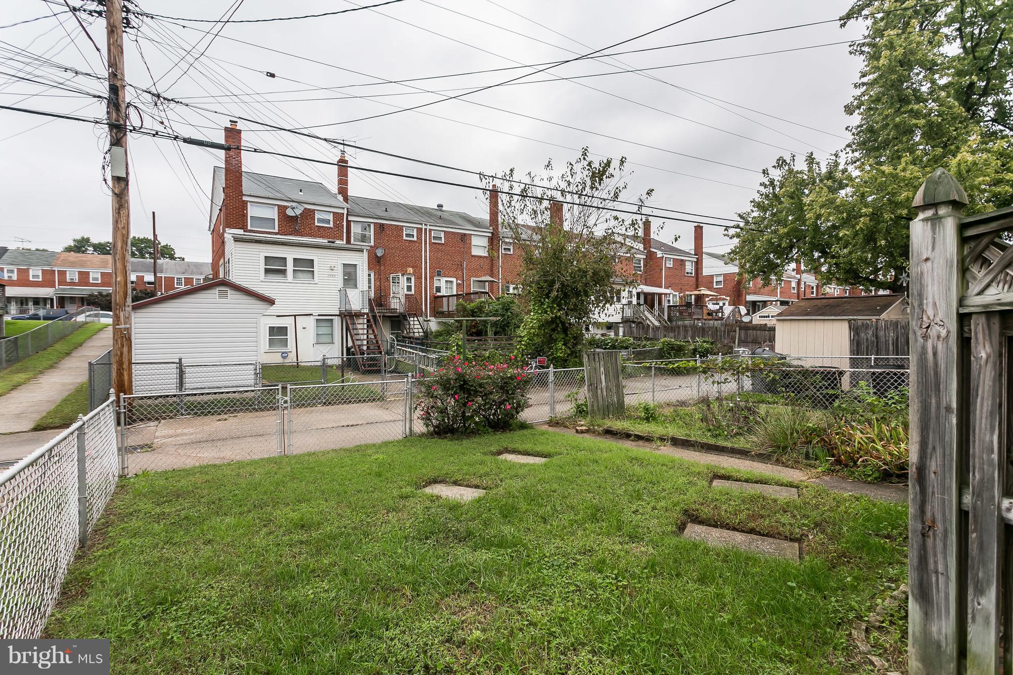 1000 Arncliffe Road Baltimore, MD 21221 - Photo 35 of 36 a view of a garden with a bench in front of house