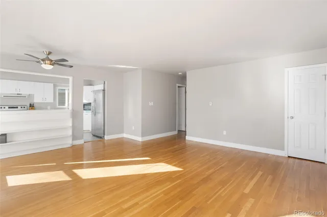 a view of a kitchen with wooden floor and a sink