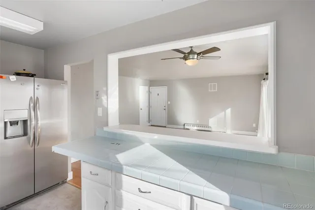 a kitchen with a refrigerator sink and cabinets