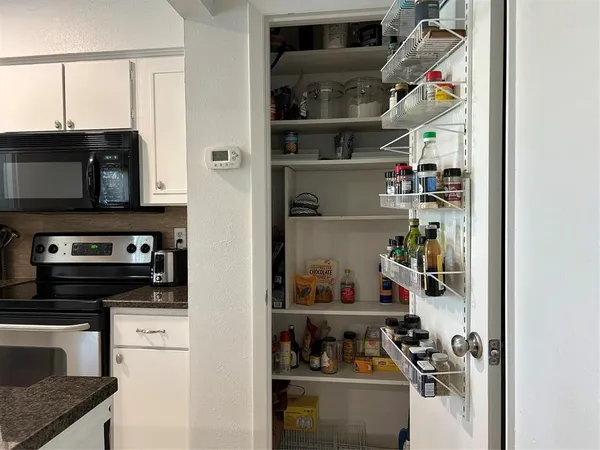 a kitchen with a refrigerator and a sink