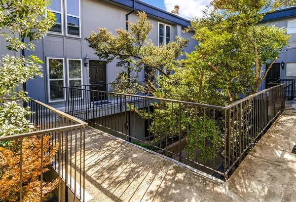 a view of a house with a small yard and large windows