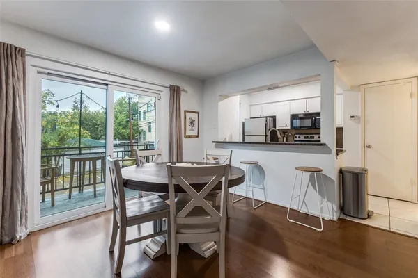 a dining room with furniture and wooden floor