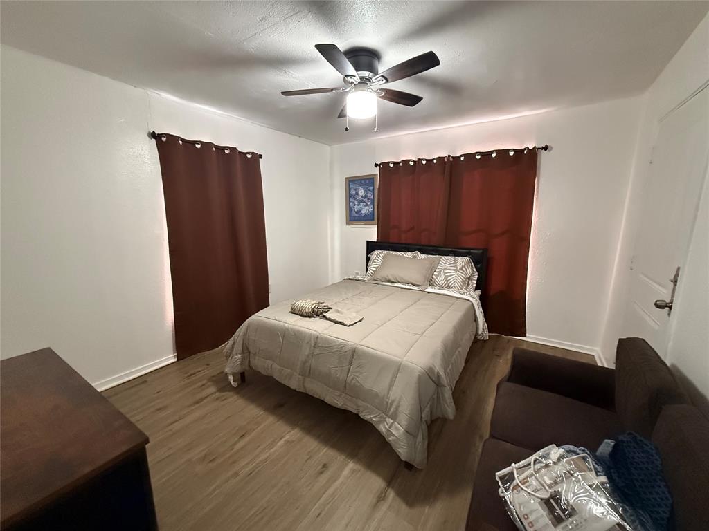 2912 Frazier Street Dallas, TX 75210 - Photo 15 of 36 a bedroom with a bed and a ceiling fan