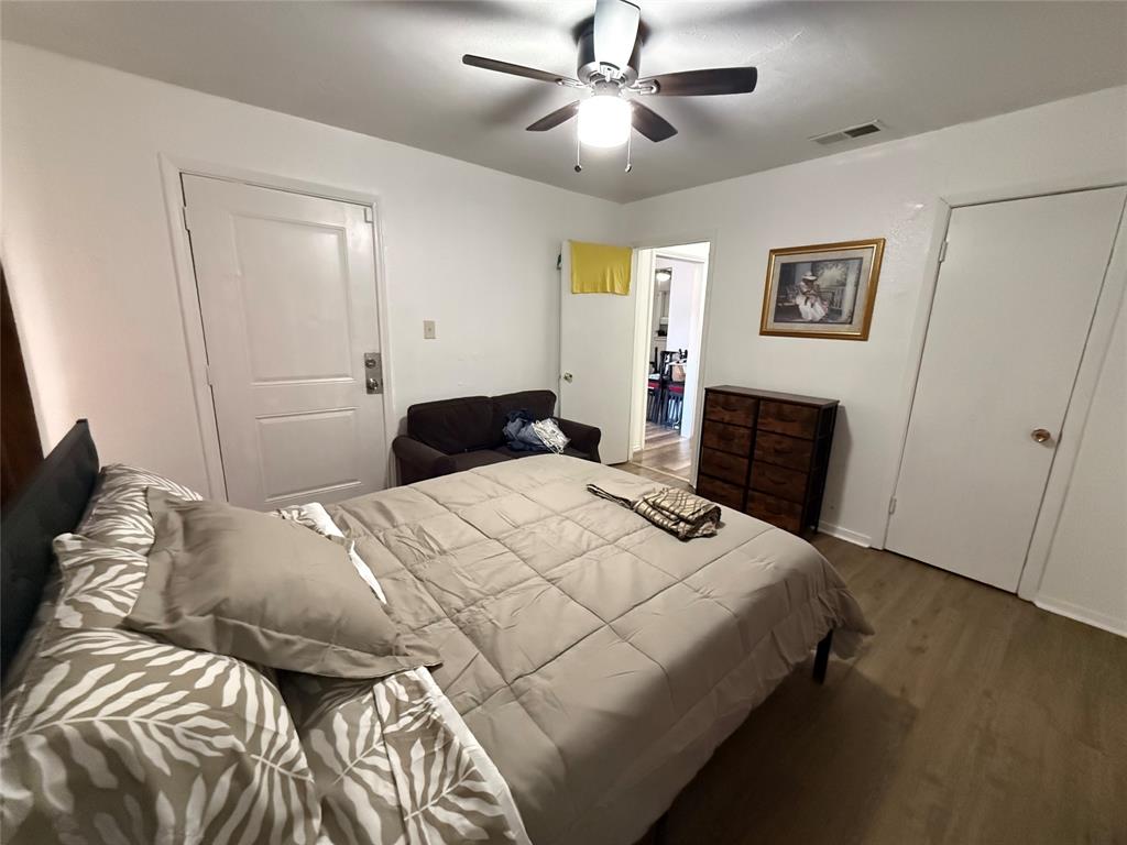 2912 Frazier Street Dallas, TX 75210 - Photo 16 of 36 a bedroom with a bed and a chandelier