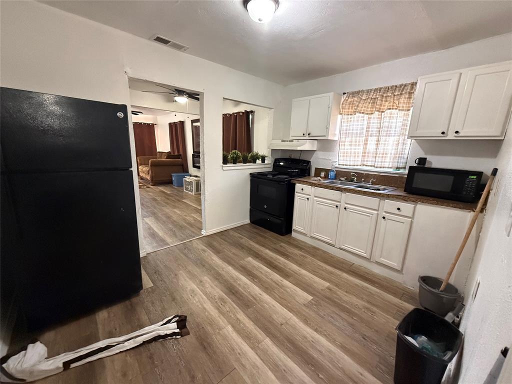 2912 Frazier Street Dallas, TX 75210 - Photo 19 of 36 a kitchen with granite countertop a refrigerator stove and sink