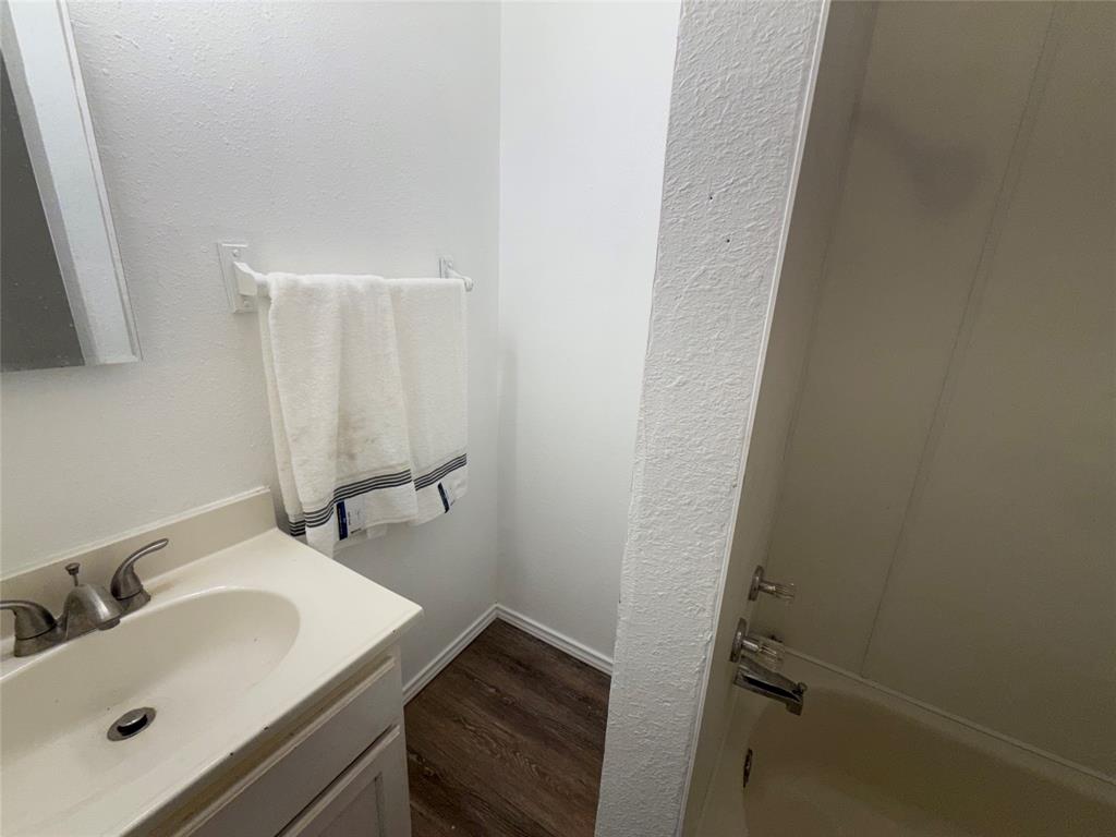 2912 Frazier Street Dallas, TX 75210 - Photo 24 of 36 a bathroom with a sink and mirror