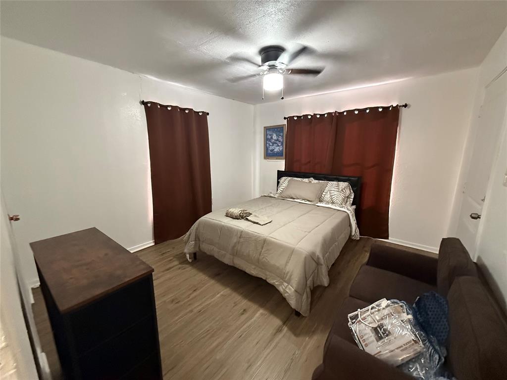 2912 Frazier Street Dallas, TX 75210 - Photo 10 of 36 a bedroom with a bed and a dresser