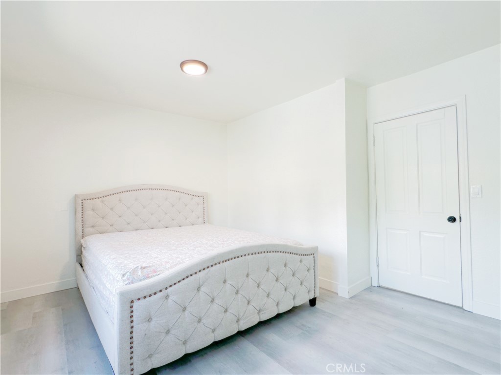 285 Parke Street Pasadena, CA 91101 - Photo 13 of 24 a room with a bed and a night stand